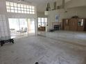 Expansive living area with tall ceilings, fireplace, and sliding glass doors leading to outdoor space at 9168 Southern Comfort Ct, Weeki Wachee, FL 34613