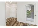 Bright foyer with wood floors, white trim, and natural light from an exterior door at 9420 Georgian Park Ln # 106, Tampa, FL 33626
