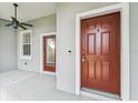 Front porch featuring a ceiling fan and exterior doors to the house at 9420 Georgian Park Ln # 106, Tampa, FL 33626