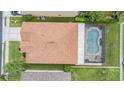 Aerial view of a home with a private screened-in pool and lush green backyard at 10435 Peppergrass Ct, Trinity, FL 34655