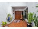 Inviting home entrance with brick flooring, double doors, and decorative plants at 11505 Cerca Del Rio, Temple Terrace, FL 33617