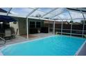 Lovely screened-in pool with an outdoor dining set and lots of space for entertaining at 11810 Oceanside Dr, Port Richey, FL 34668