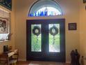 Elegant front entry featuring a stained glass double-door, topped with a decorative transom window and interior design at 1231 Etta Ave, Spring Hill, FL 34609