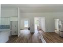Open-concept space with wood-look floors and bright natural light, flowing through the house at 14586 Mocking Wren Rd, Weeki Wachee, FL 34614