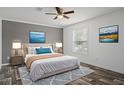 Comfortable bedroom with neutral colors, a ceiling fan, and stylish artwork, creating a peaceful retreat at 16104 Naples St, Brooksville, FL 34604