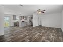 Expansive living room featuring modern flooring and an open layout seamlessly connecting to the stylish kitchen at 16104 Naples St, Brooksville, FL 34604