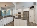 Bright kitchen features white cabinets, stainless steel appliances, granite countertops, and a stylish backsplash at 1831 Cardamon Dr, Trinity, FL 34655
