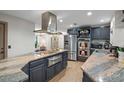 Stylish kitchen featuring stainless steel appliances, granite countertops, and wooden floors at 34955 Blanton Rd, Dade City, FL 33523
