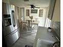 Well-lit dining area with modern refrigerator and a charming 'sweet home' wall decor at 5208 Chet Dr, New Port Richey, FL 34652