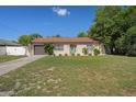 Inviting single-story home with a lush green lawn, tidy landscaping, and an attached garage at 6347 Shadydale Ave, Spring Hill, FL 34609