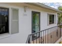 Inviting condo entrance featuring a secure door and updated exterior lighting at 6462 River Run Blvd, Weeki Wachee, FL 34607