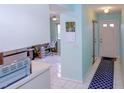 Bright entryway with tile flooring, leading to an open office area and interior rooms at 6462 River Run Blvd, Weeki Wachee, FL 34607
