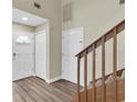 Bright foyer featuring wood-look floors, staircase and neutral walls at 7230 Hummingbird Ln, New Port Richey, FL 34655