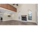 Spacious living room with wood floors, a cozy fireplace, high ceilings and plentiful natural light at 7230 Hummingbird Ln, New Port Richey, FL 34655