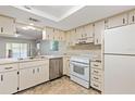 Open kitchen view highlighting stainless steel dishwasher and seamlessly connected living space at 7700 Danube Dr # 7700, Hudson, FL 34667
