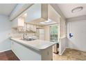 Well-lit kitchen with a functional layout, breakfast bar, and easy access to other rooms at 7700 Danube Dr # 7700, Hudson, FL 34667