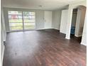 Living room with hardwood floors and large windows providing lots of light at 7714 Fox Hollow Dr, Port Richey, FL 34668