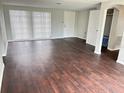 Bright living room featuring wood floors and a closet at 7714 Fox Hollow Dr, Port Richey, FL 34668