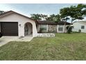 Single-story home with a stone facade detail and a one car garage at 8516 Inwood Dr, Hudson, FL 34667