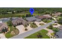 Desirable neighborhood featuring a lake view, well-manicured lawns, and a community pool at 9188 Mississippi Run, Weeki Wachee, FL 34613