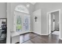 Bright foyer with decorative glass double doors and elegant tile flooring at 9212 Calle Alta, New Port Richey, FL 34655