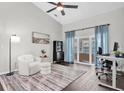 Inviting living room with ample natural light, ceiling fan, and sliding glass doors at 9212 Calle Alta, New Port Richey, FL 34655
