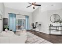 Bright living room featuring hardwood floors, modern furniture, and backyard access at 9212 Calle Alta, New Port Richey, FL 34655