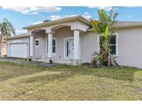 Charming single-story home with a stucco exterior, arched entryway, and well-maintained lawn at 2781 Shady Ave, North Port, FL 34286