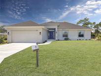 Single-story home with attached garage and manicured lawn at 1139 Euclid Rd, Venice, FL 34293