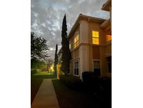 Attractive building exterior at dusk, featuring a walkway and landscaping at 1010 Villagio Cir # 106, Sarasota, FL 34237