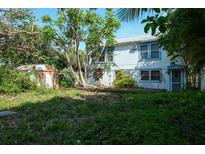 Large backyard with mature trees and a shed at 106 11Th S St # A, Bradenton Beach, FL 34217