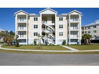 Three-story building with multiple units, balconies, and landscaped grounds at 3426 79Th Street W Cir # 202, Bradenton, FL 34209