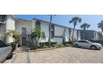 Modern condo building with ample parking and landscaping at 1046 W Peppertree Ln # 115B, Sarasota, FL 34242