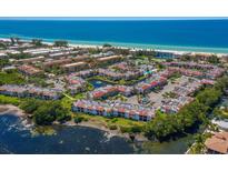 Aerial view of a coastal community with beachfront property and resort-style amenities at 1801 Gulf N Dr # 248, Bradenton Beach, FL 34217