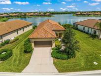 Single-Gathering home with lake view and two-car garage at 243 Cassano Dr, Nokomis, FL 34275