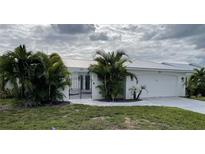 Single-story home with white exterior at 676 Key Royale Drive, Holmes Beach, FL 34217