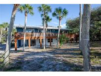 Elevated home with expansive deck overlooking treetops at 7720 Manasota Key Rd, Englewood, FL 34223