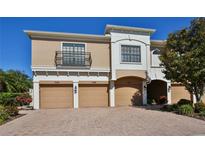 Elegant townhome exterior with three garage doors and decorative architectural details at 7330 Skybird Rd # 7330, Bradenton, FL 34209