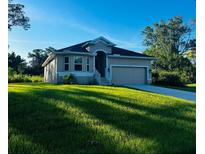 Single-story home with attached garage and lush lawn at 5655 Hale Rd, Venice, FL 34293