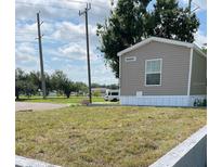 Tan mobile home with a grassy yard at 4772 Duncan Rd, Punta Gorda, FL 33982
