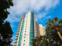High-rise building with modern design, balconies, and palm trees at 340 S Palm Ave # 15, Sarasota, FL 34236