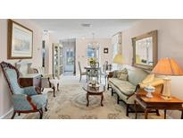 Elegant living room with antique furniture and a chandelier at 6033 Arlene Way # 3, Bradenton, FL 34207