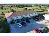 An aerial view of a townhome building with parking and a golf course view at 26356 Nadir Rd # 101, Punta Gorda, FL 33983