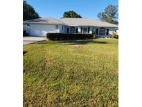 Charming single-story home with manicured lawn and attached two-car garage at 4512 Ulster Ave, North Port, FL 34287