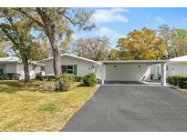 Single story home with carport and well maintained lawn at 3915 Schwalbe Dr # 128, Sarasota, FL 34235