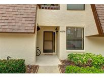Condo building exterior with walkway and landscaping at 4576 Ringwood Mdw # 5, Sarasota, FL 34235