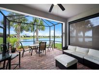 Relaxing screened porch overlooking a lake, with seating and dining areas at 6919 Dorset Ct, Lakewood Ranch, FL 34202