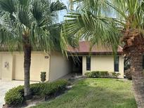 Front view of condo, showcasing landscaping and garage at 3607 Pine Point Ct # 119, Sarasota, FL 34238