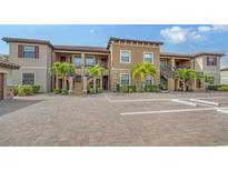 Tan building exterior with multiple units and parking at 12409 Osorio Ct # 101, Sarasota, FL 34238