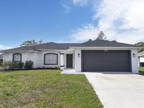 Single-story house with a gray garage door at 4233 Danbury Ter, North Port, FL 34286